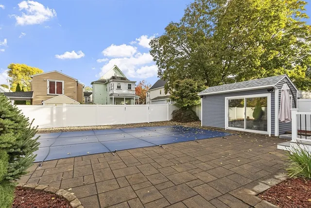 a view of a house with a yard and large tree