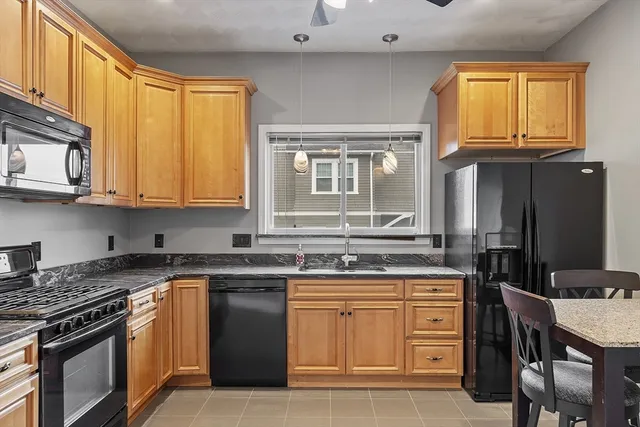 a kitchen with stainless steel appliances granite countertop a stove and a microwave