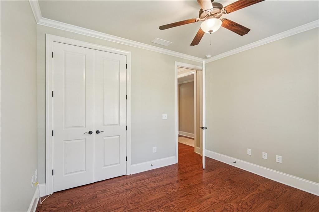 488 Townsend Street Grayson, GA 30017 - Photo 21 of 40 an empty room with wooden floor closet and windows