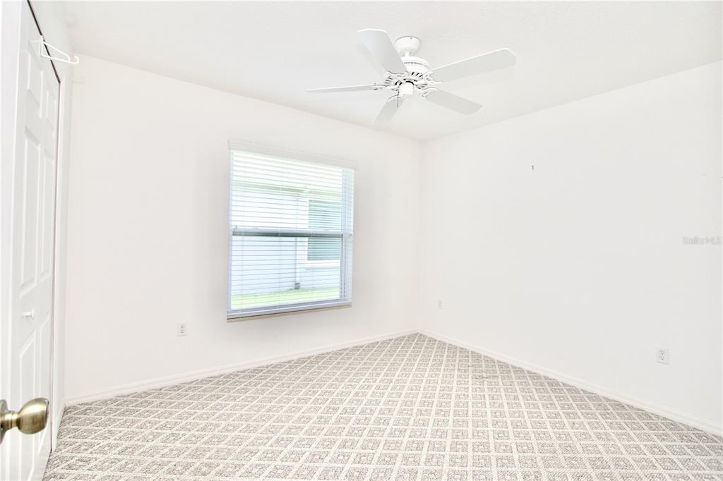 7842 Tenby Court New Port Richey, FL 34655 - Photo 7 of 27 a view of an empty room with a window