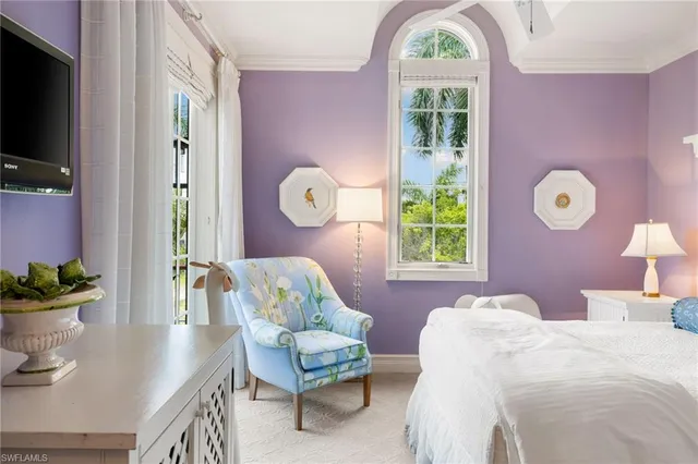 a bed room with a bed and a chair