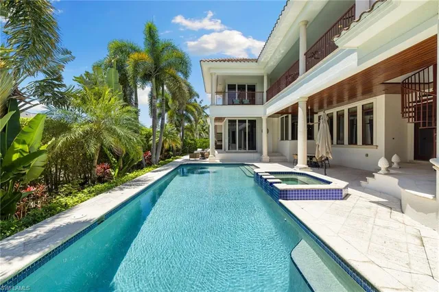 a view of a house with swimming pool and sitting area