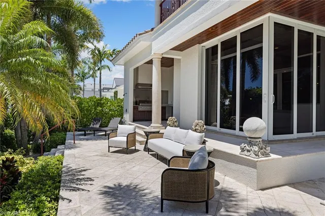 a building outdoor space with patio furniture and potted plants