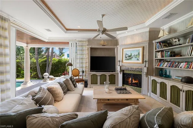 a living room with fireplace furniture and a flat screen tv