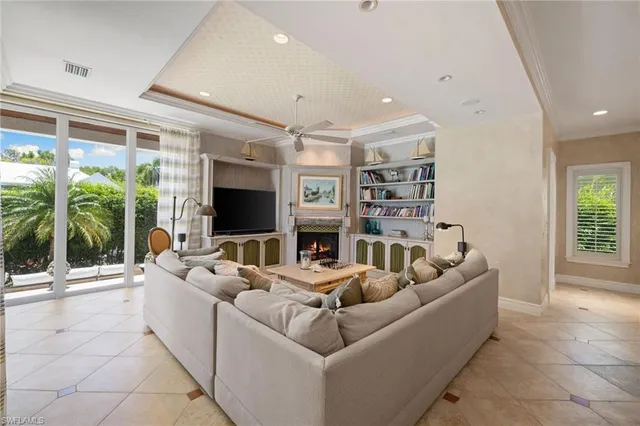 a living room with fireplace furniture and a flat screen tv