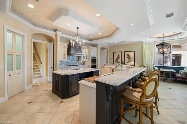 a kitchen with stainless steel appliances kitchen island granite countertop a table and chairs in it