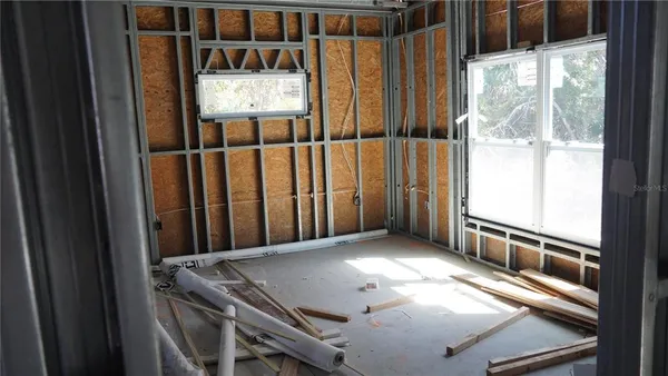 a view of a room with wooden floor and windows