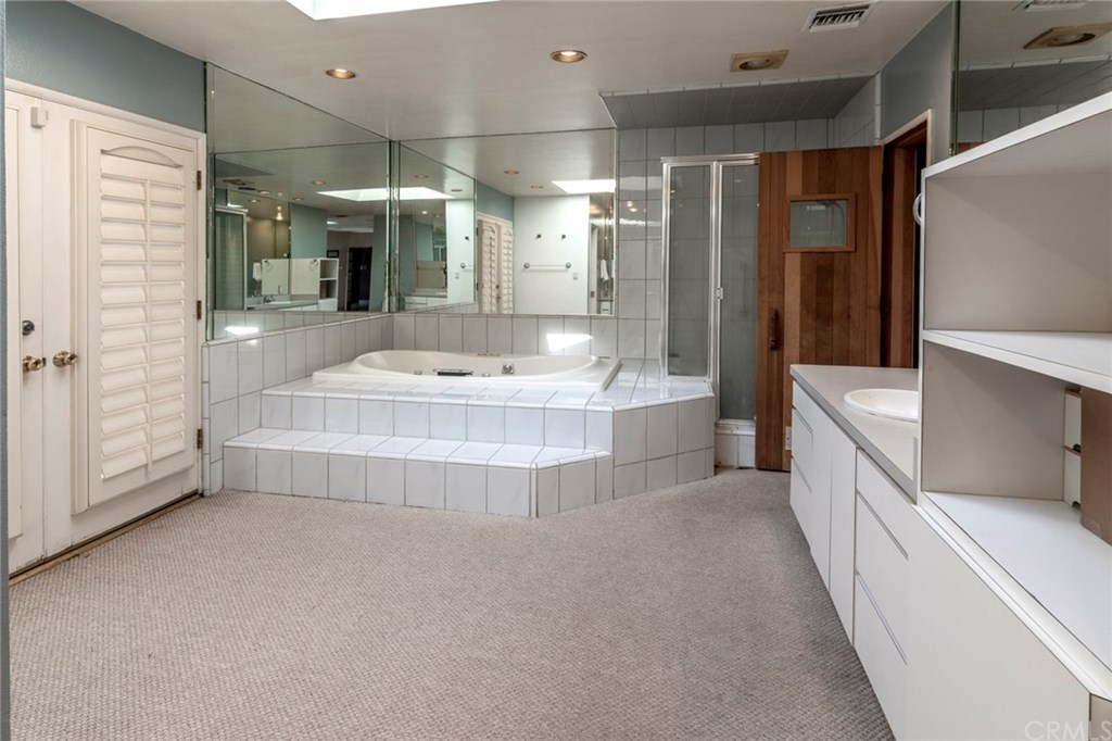 1425 Miramar Drive Fullerton, CA 92831 - Photo 43 of 55 a bathroom with a tub a double vanity sink and mirror