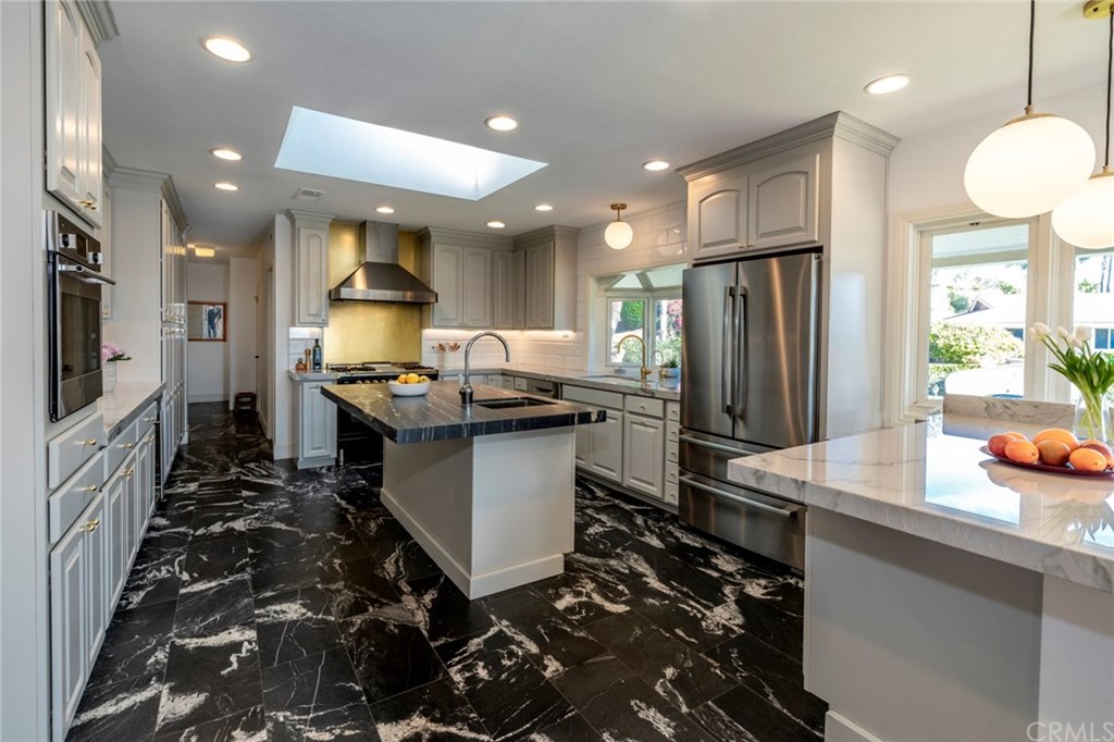 1425 Miramar Drive Fullerton, CA 92831 - Photo 6 of 55 a kitchen with sink refrigerator and cabinets