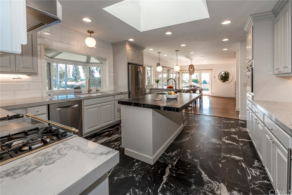 1425 Miramar Drive Fullerton, CA 92831 - Photo 7 of 55 a kitchen with kitchen island a stove a sink and a refrigerator