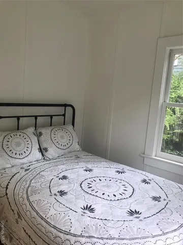 a view of a bedroom with furniture