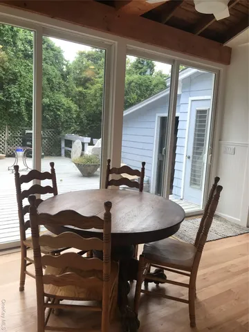 a view of a dining room with furniture window and outside view