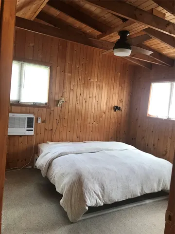 a bedroom with a bed and a window