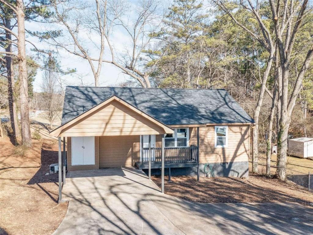 2426 Lake Harbin Road Morrow, GA 30260 - Photo 1 of 1 a house with trees in front of it