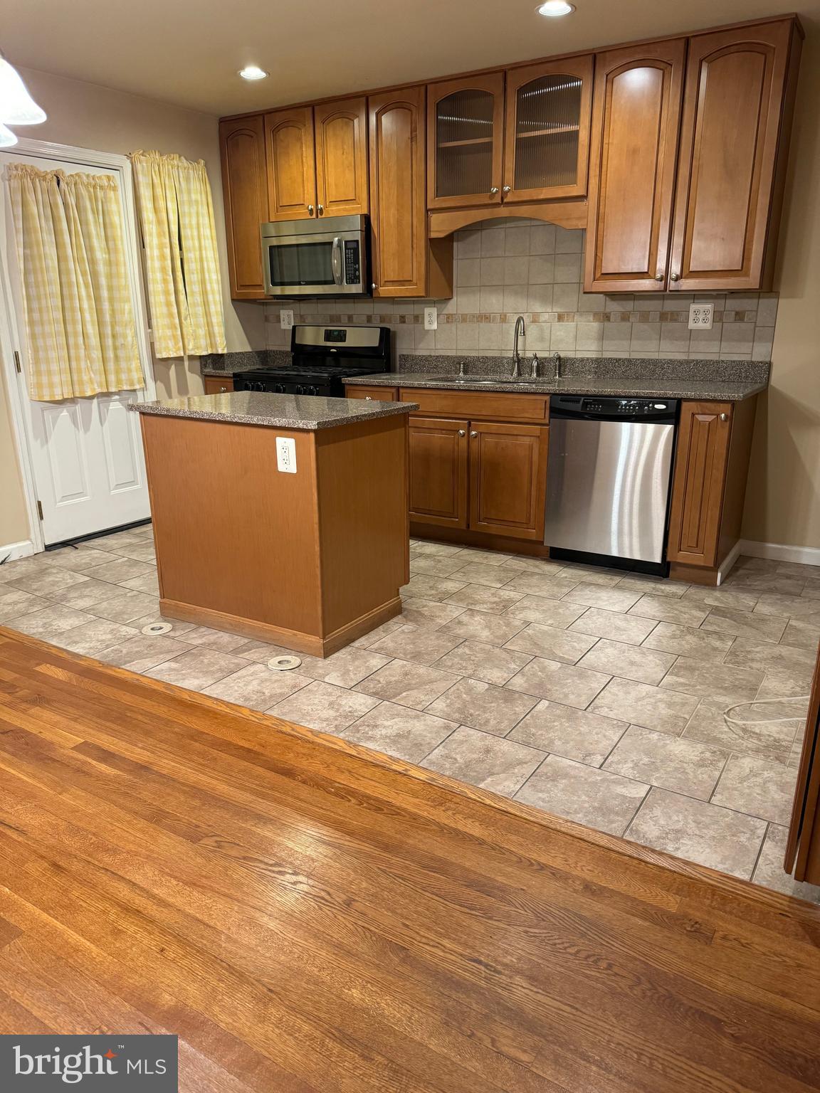1513 Aldeney Avenue Middle River, MD 21220 - Photo 3 of 34 a kitchen with stainless steel appliances granite countertop a stove a sink and a microwave