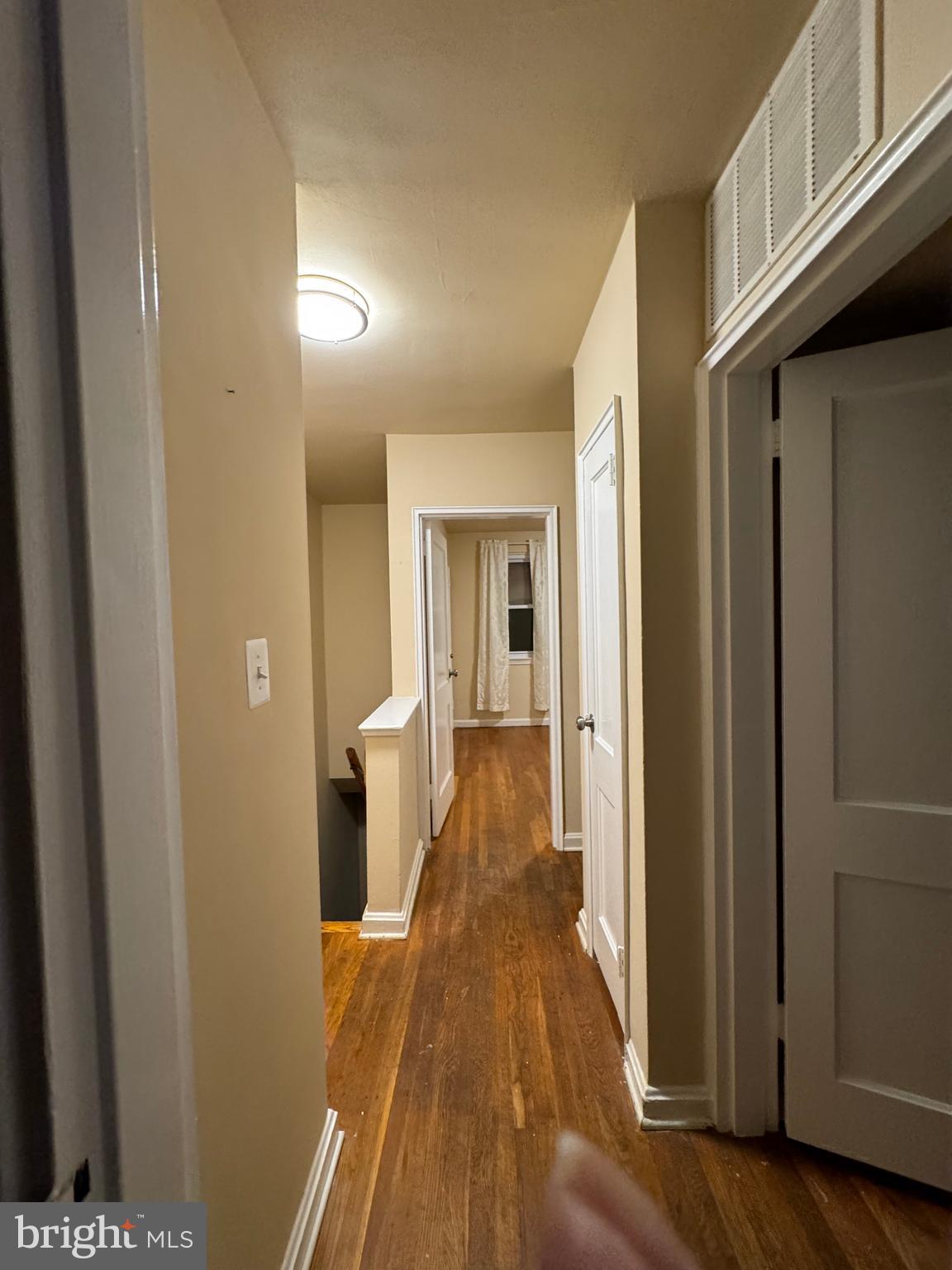 1513 Aldeney Avenue Middle River, MD 21220 - Photo 32 of 34 a view of a hallway with wooden floor and staircase