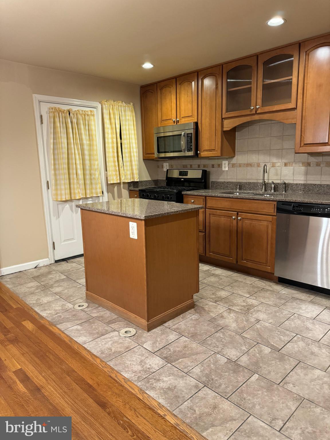 1513 Aldeney Avenue Middle River, MD 21220 - Photo 5 of 34 a kitchen with stainless steel appliances granite countertop a stove a sink and a microwave