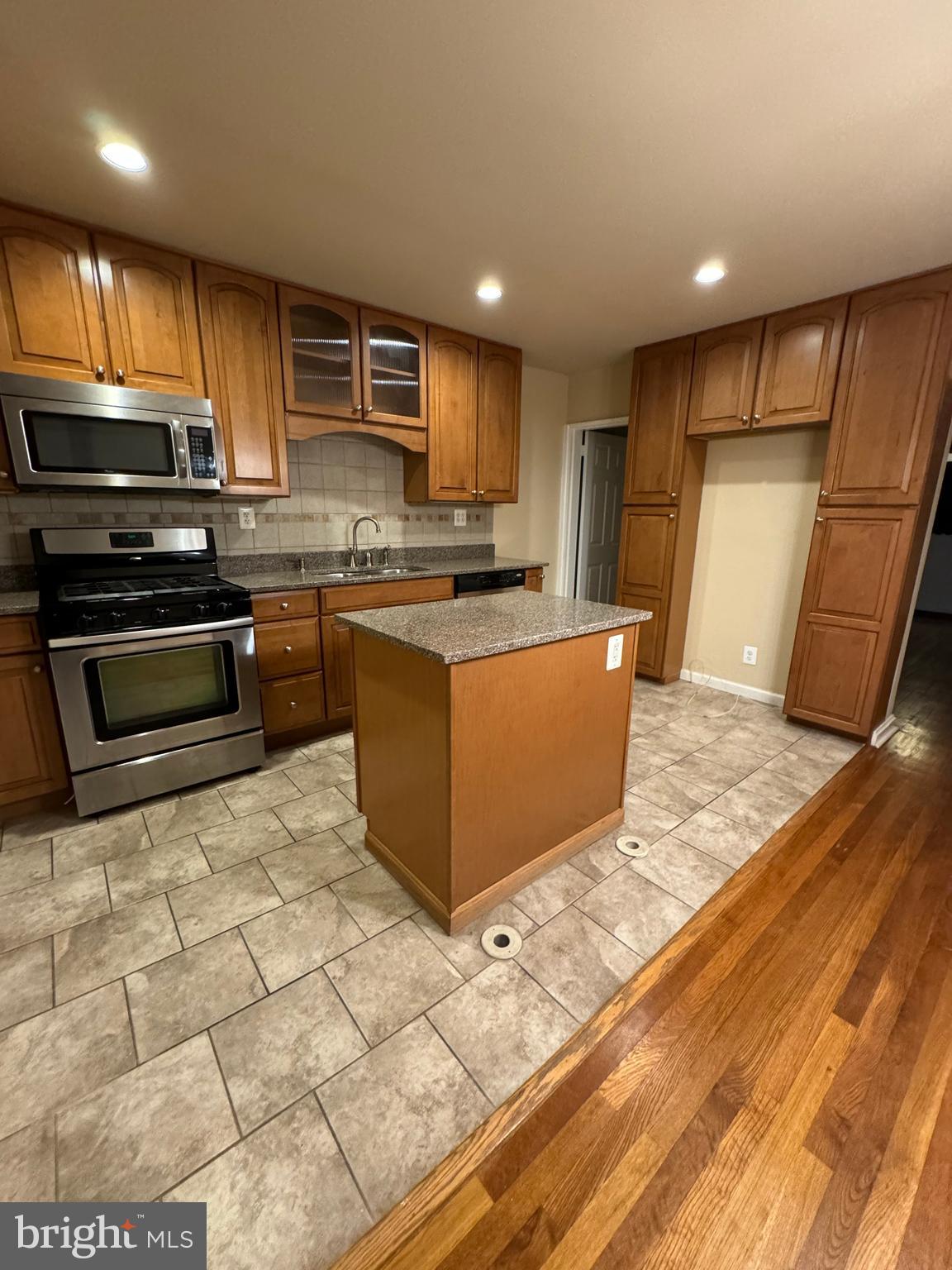 1513 Aldeney Avenue Middle River, MD 21220 - Photo 7 of 34 a kitchen with stainless steel appliances granite countertop a refrigerator a stove a sink and a microwave