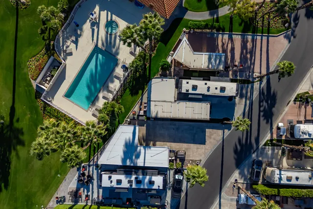 an aerial view of a house with a yard and lake view