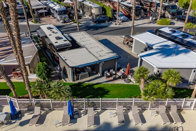 a view of a patio with table and chairs potted plants and a palm tree