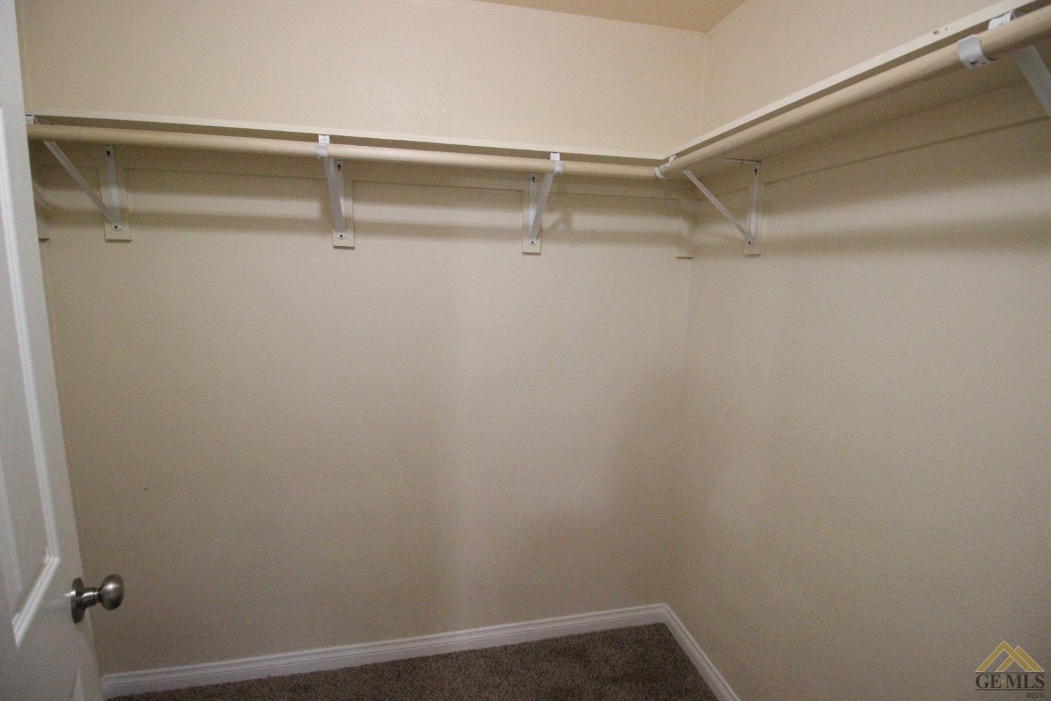 Undisclosed Address Bakersfield, CA 93308 - Photo 12 of 25 a view of an empty walk in closet