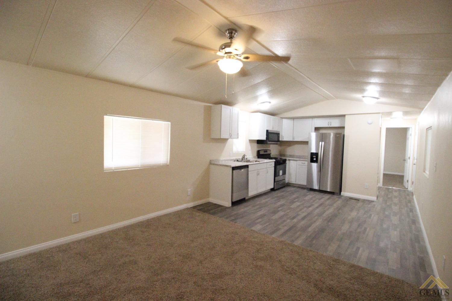 Undisclosed Address Bakersfield, CA 93308 - Photo 2 of 25 a view of a kitchen with a sink stove refrigerator and cabinets