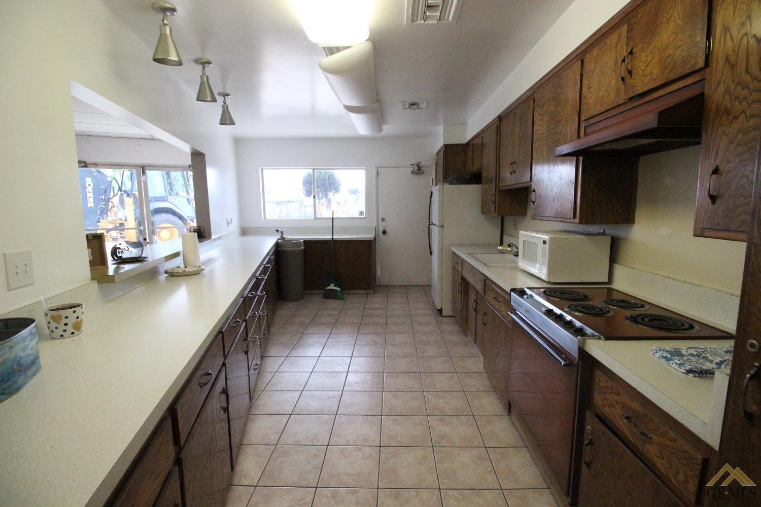 Undisclosed Address Bakersfield, CA 93308 - Photo 23 of 25 a kitchen with stainless steel appliances a stove sink and cabinets