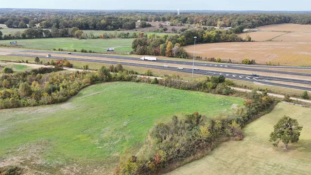 an aerial view of a house with a yard and lake view