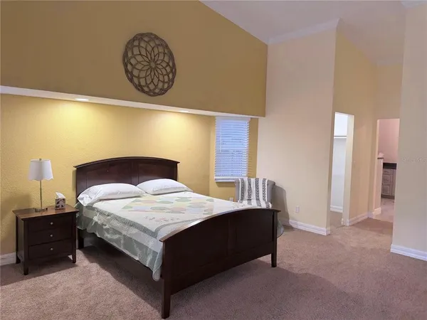 a bedroom with a bed and a table