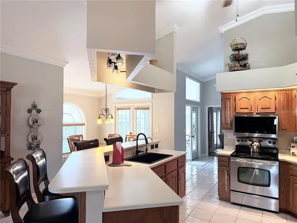 a kitchen with stainless steel appliances a stove a sink and a refrigerator