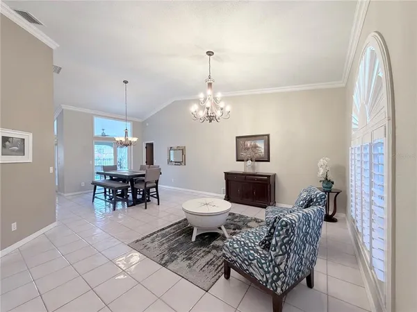 a living room with furniture a dining table and a fireplace