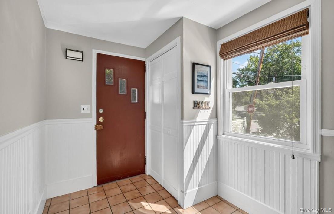 34 Ridge Road Croton-on-Hudson, NY 10520 - Photo 3 of 34 Foyer entrance features the coat closet, tile floors and a wainscoted wall