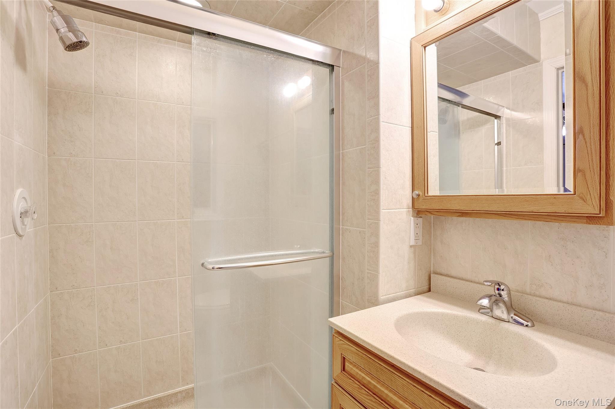 8 Swallow Avenue Spring Valley, NY 10977 - Photo 14 of 28 a bathroom with a sink and a mirror