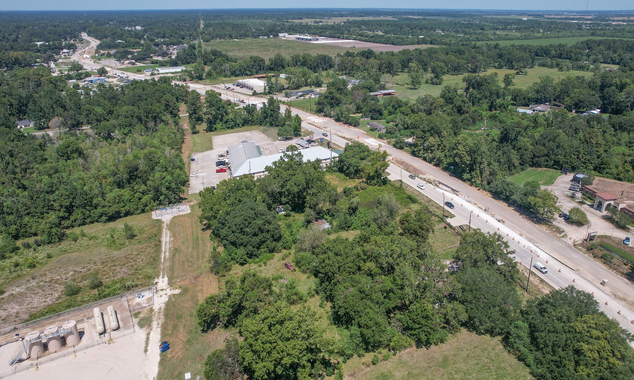 24411 Farm To Market 2100 Huffman, TX 77336 - Photo 15 of 18 an aerial view of green landscape with trees houses and mountain view