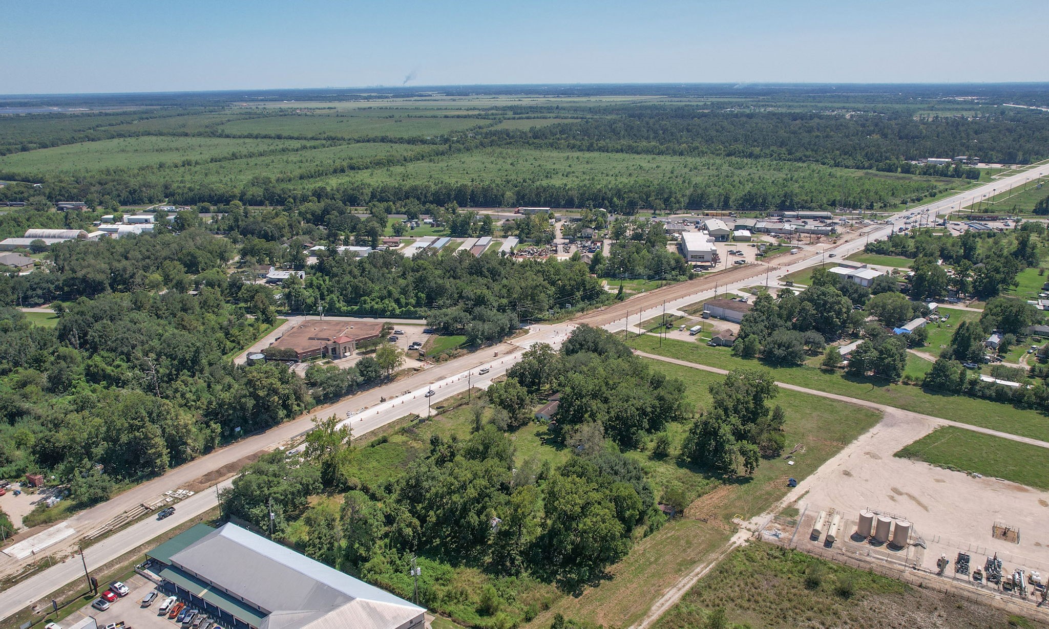 24411 Farm To Market 2100 Huffman, TX 77336 - Photo 7 of 18 a view of a city with lush green forest