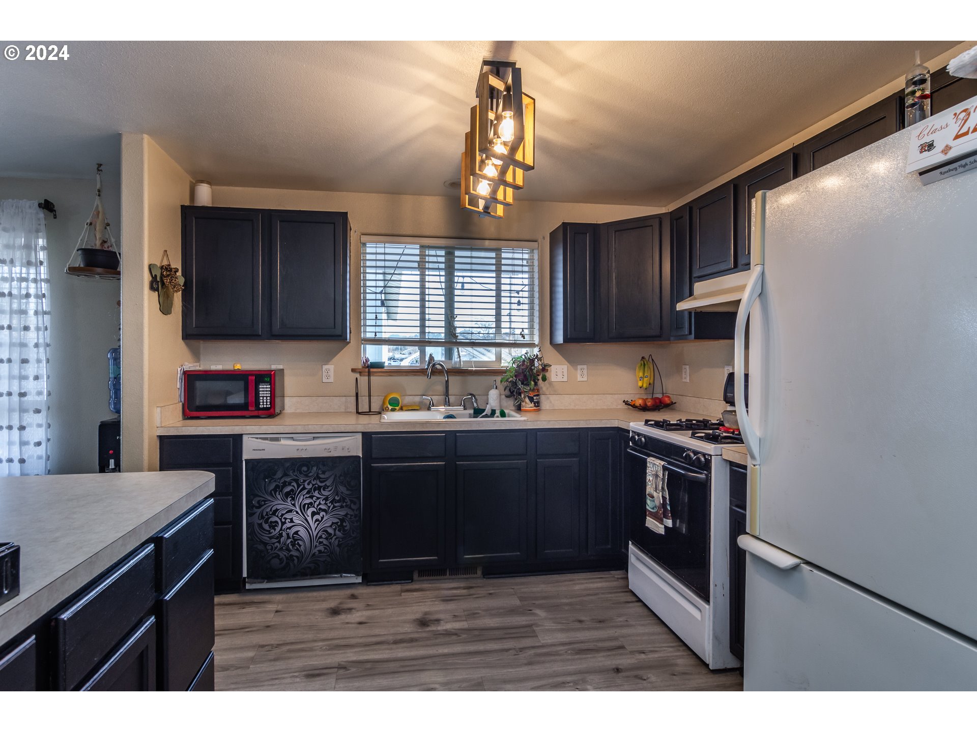 1958 Austin Road Roseburg, OR 97471 - Photo 17 of 39 a kitchen with granite countertop a stove cabinets and window