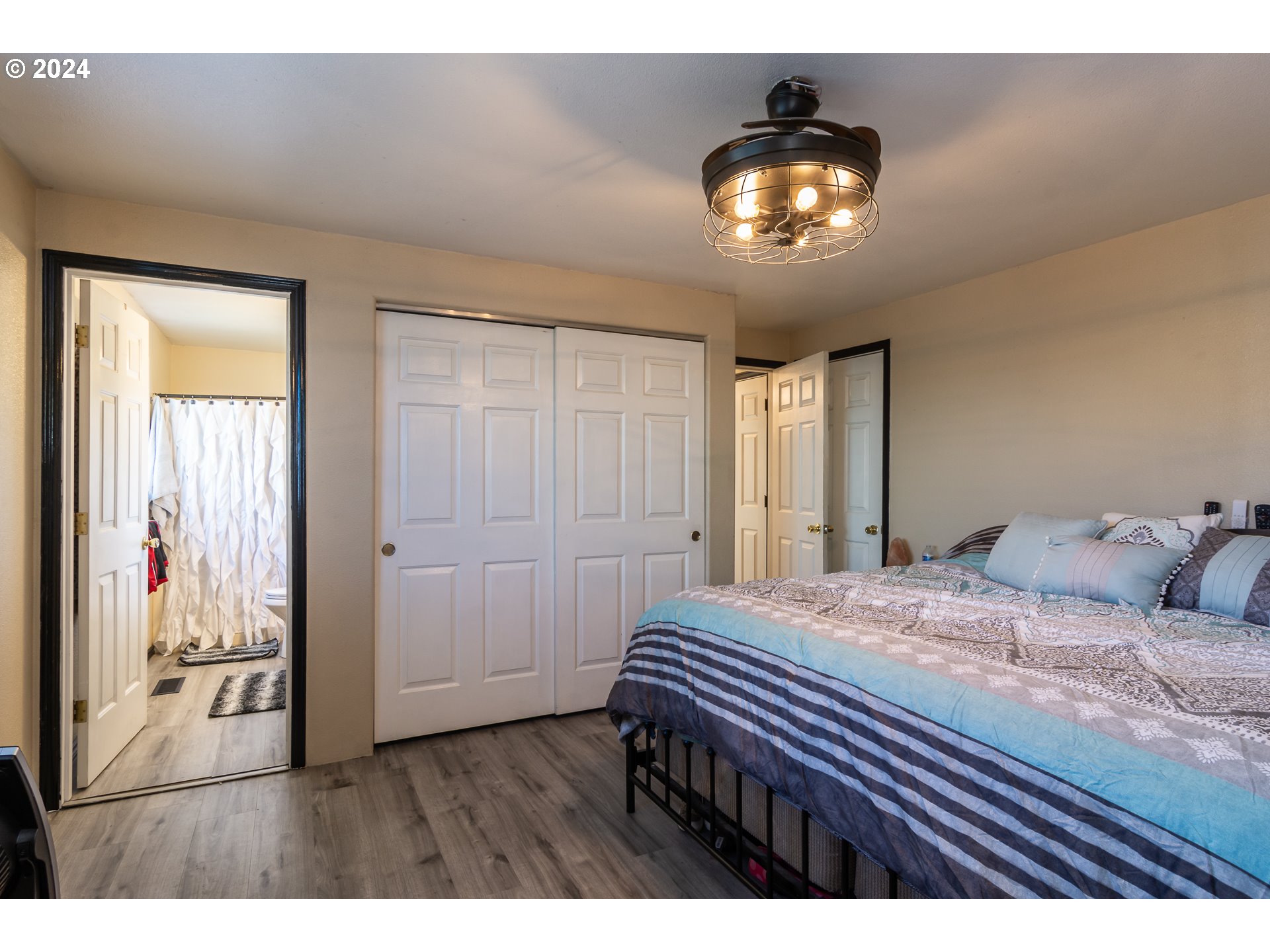 1958 Austin Road Roseburg, OR 97471 - Photo 20 of 39 a bedroom with a bed and a chandelier