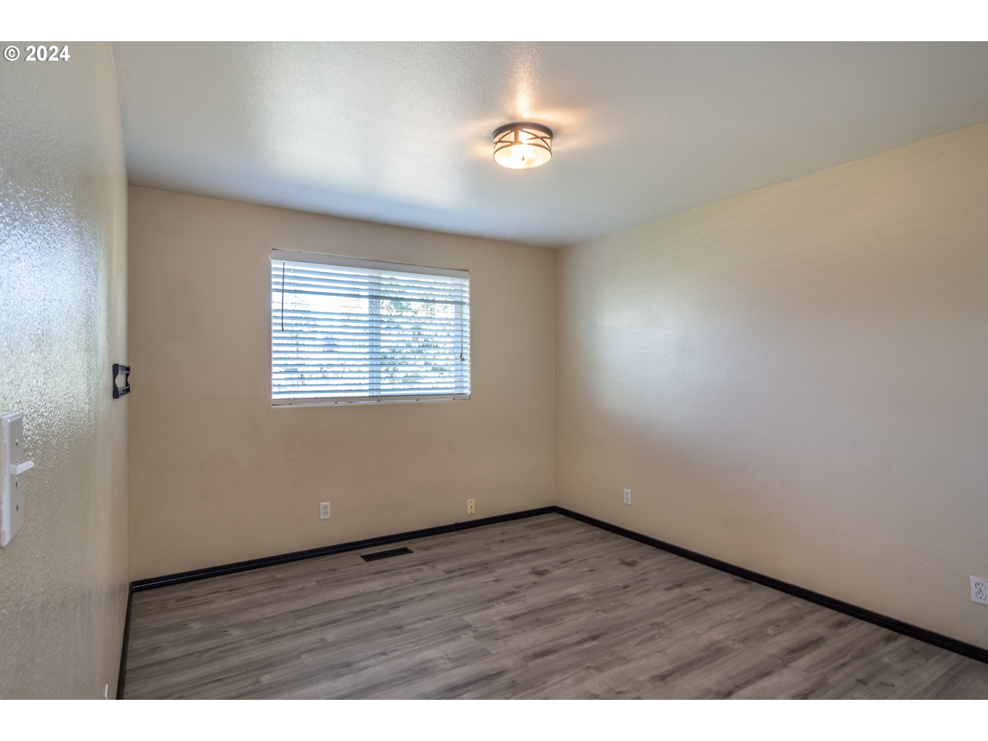 1958 Austin Road Roseburg, OR 97471 - Photo 25 of 39 a view of an empty room with wooden floor and a window