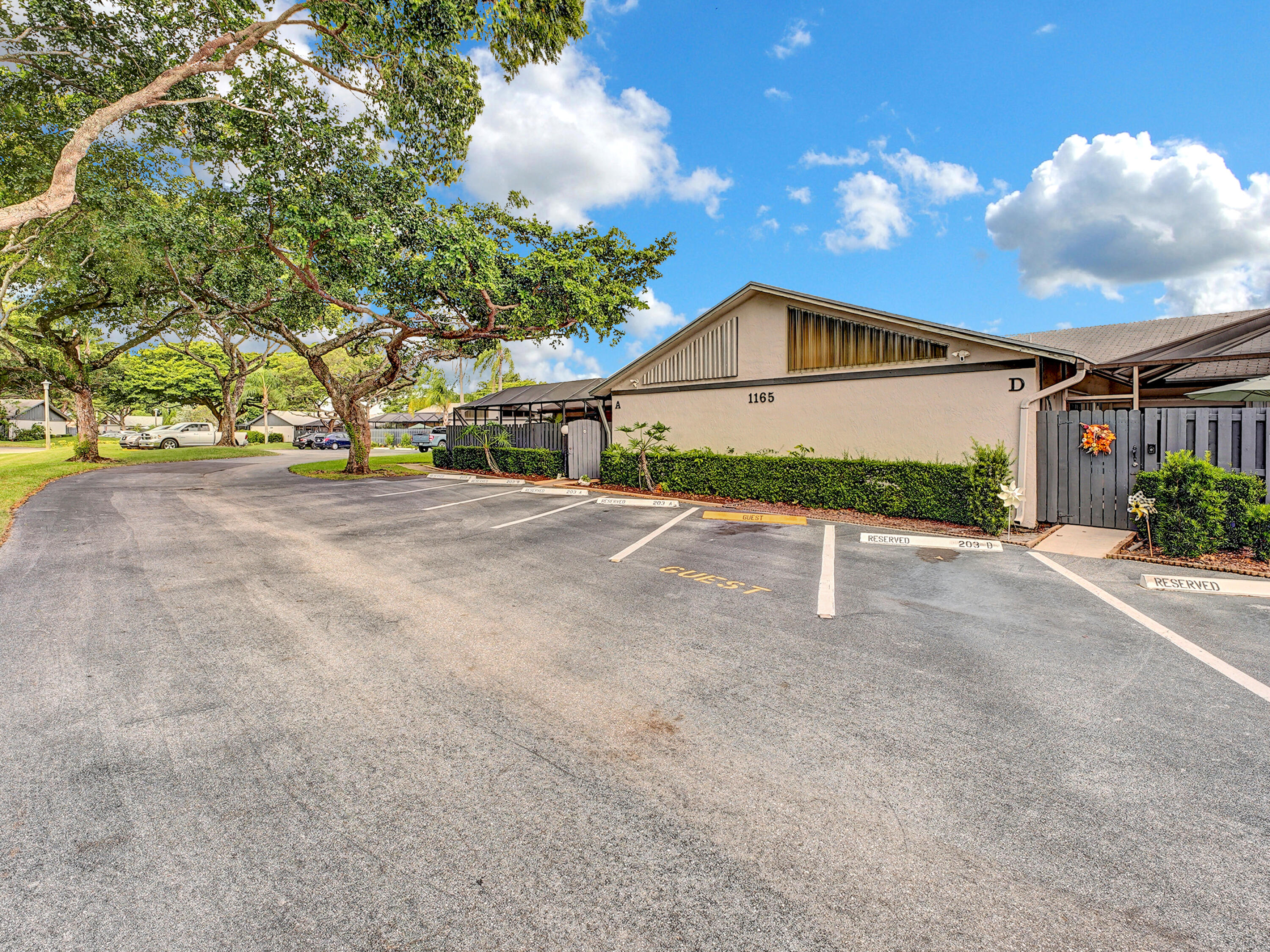 1165 Summit Trail Circle, Unit A West Palm Beach, FL 33415 - Photo 2 of 37 a view of an house with backyard and bushes