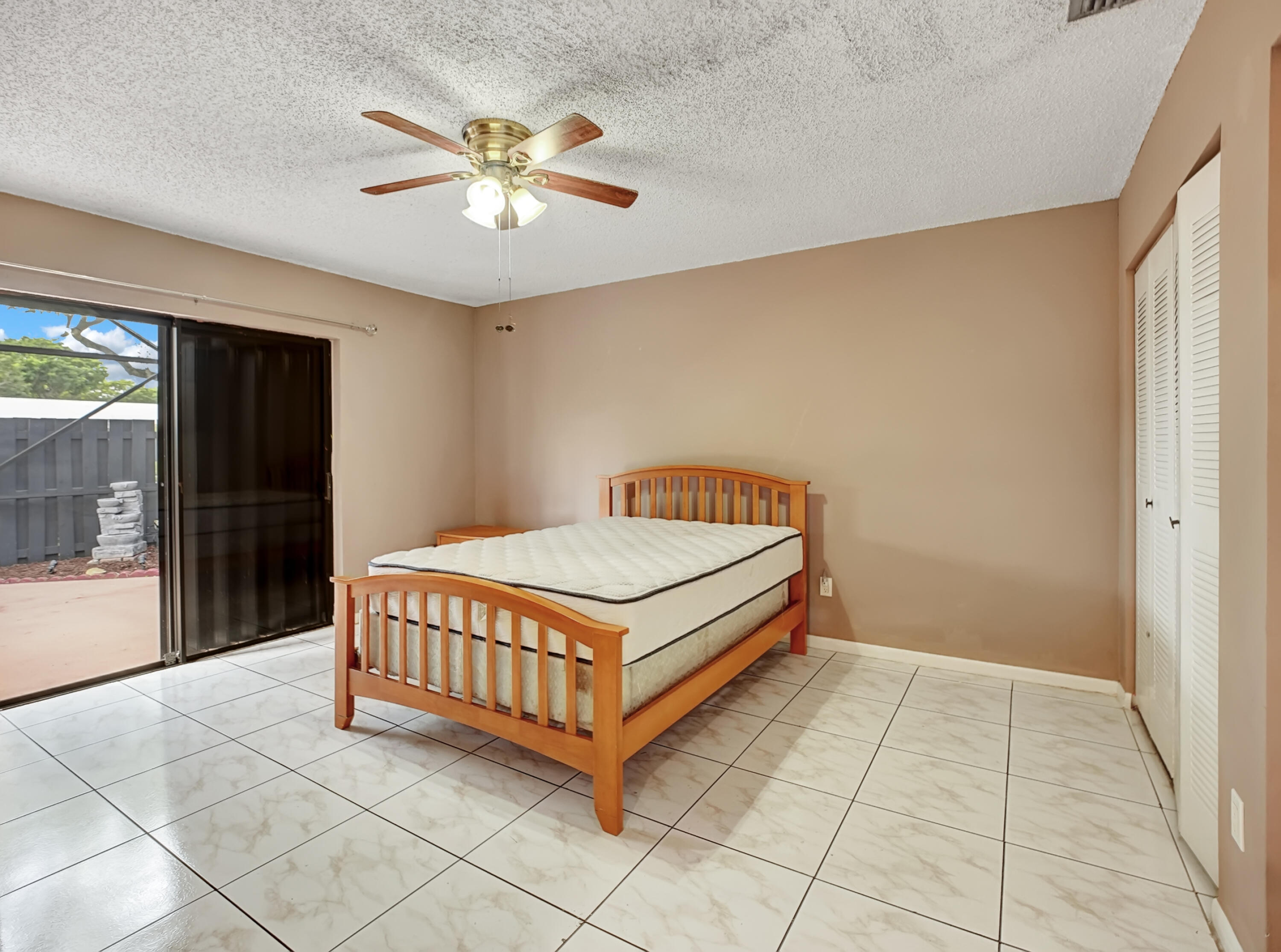 1165 Summit Trail Circle, Unit A West Palm Beach, FL 33415 - Photo 21 of 37 a room with a bed and window