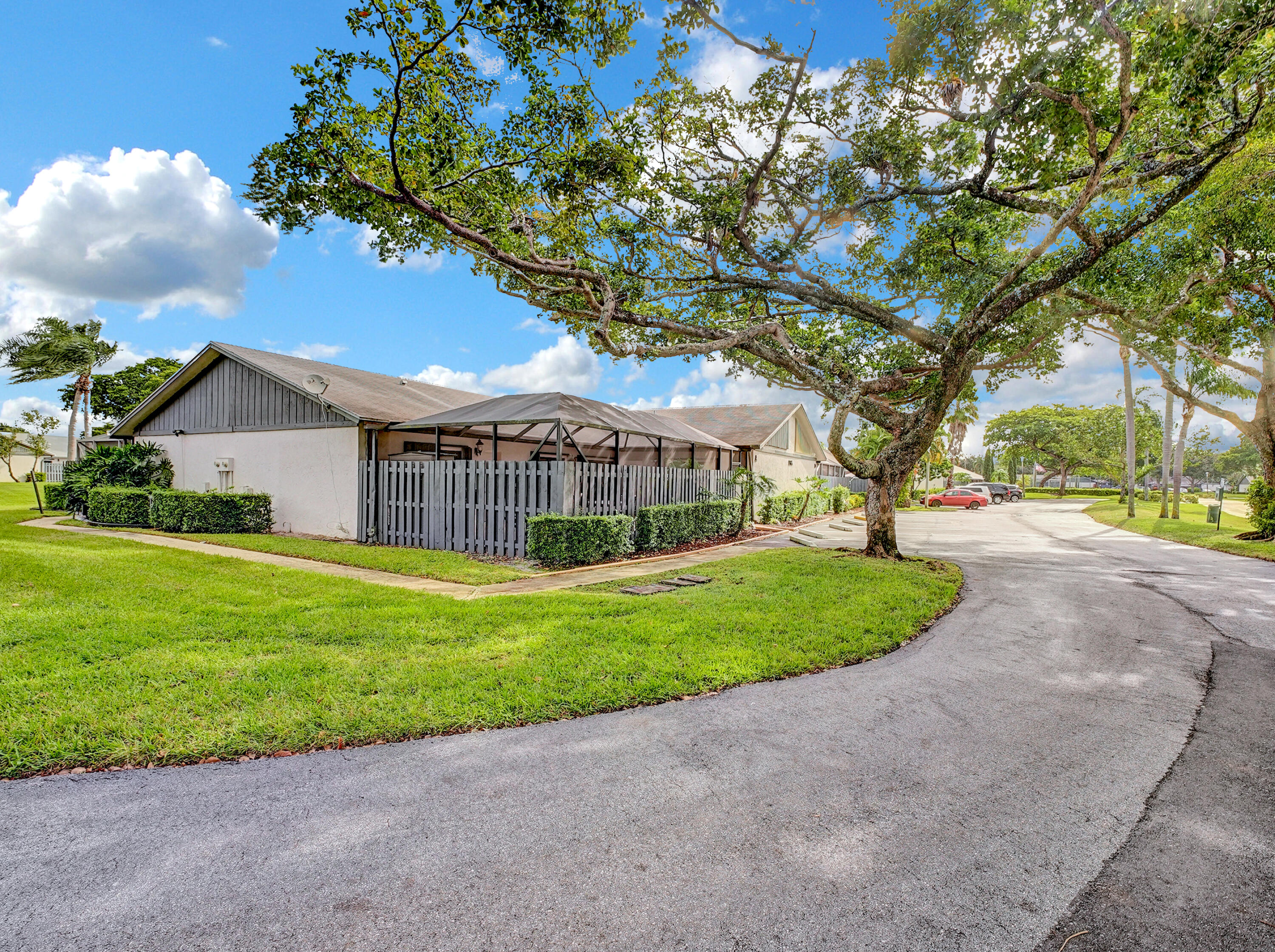 1165 Summit Trail Circle, Unit A West Palm Beach, FL 33415 - Photo 24 of 37 a view of a house with a tree and a yard
