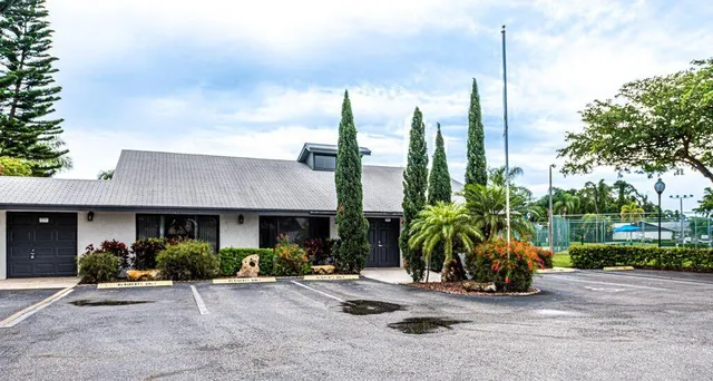 a view of a house with sitting area and potted plants