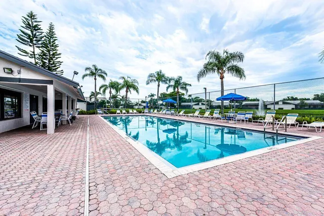 a view of swimming pool with outdoor seating and plants