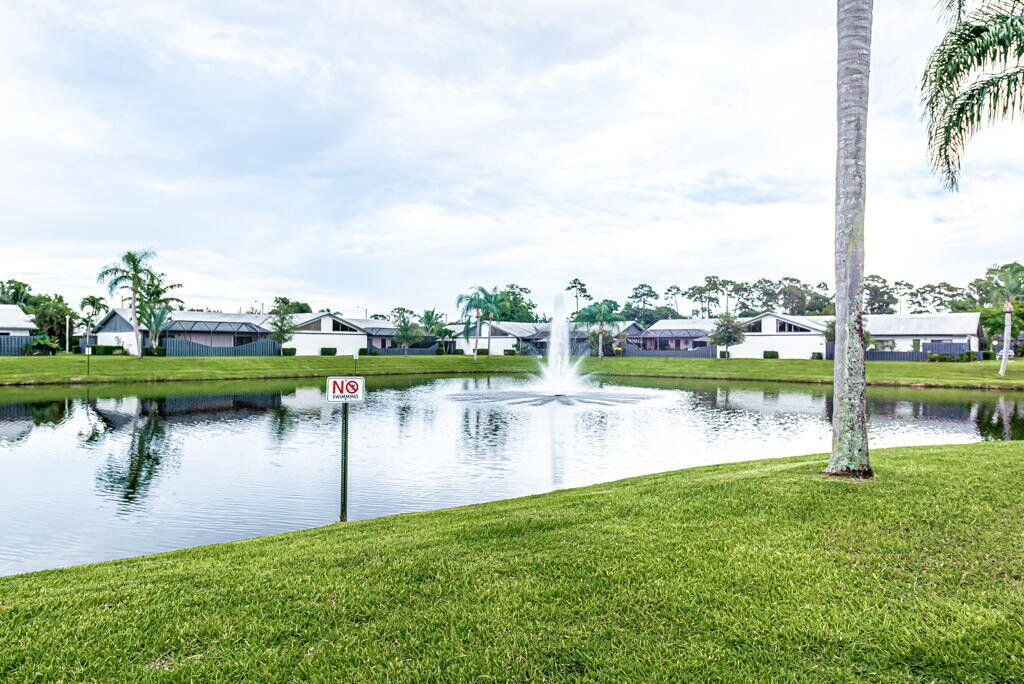 1165 Summit Trail Circle, Unit A West Palm Beach, FL 33415 - Photo 37 of 37 a lake view with a garden