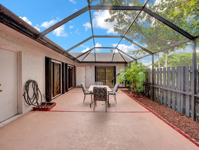 a patio with a patio table and chairs