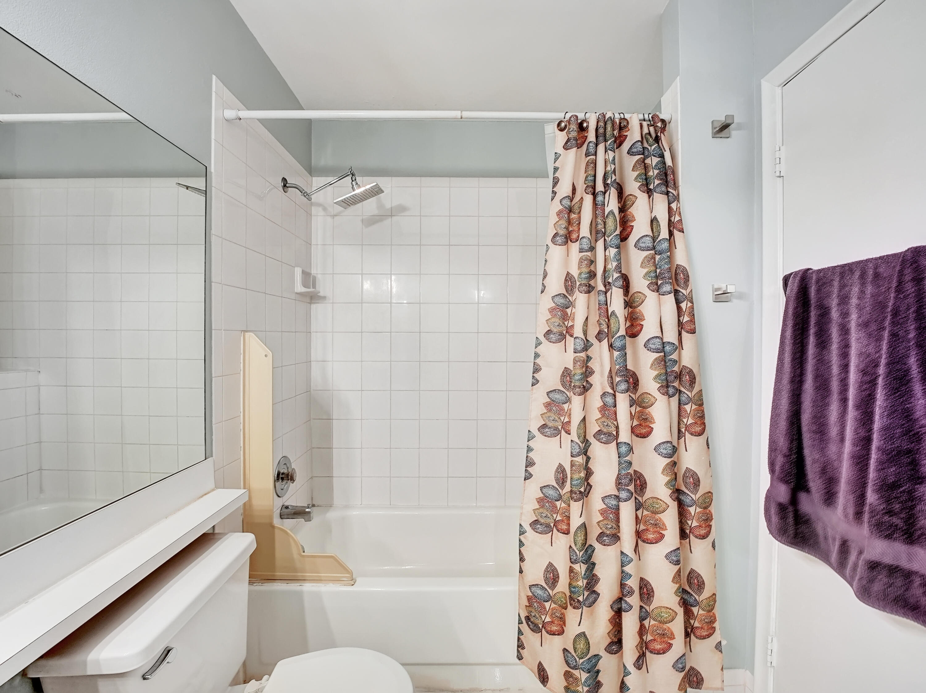 1165 Summit Trail Circle, Unit A West Palm Beach, FL 33415 - Photo 9 of 37 a bathroom with a shower curtain and a bathtub