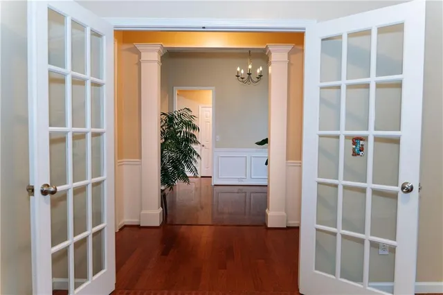 a view of entryway with wooden floor and front door