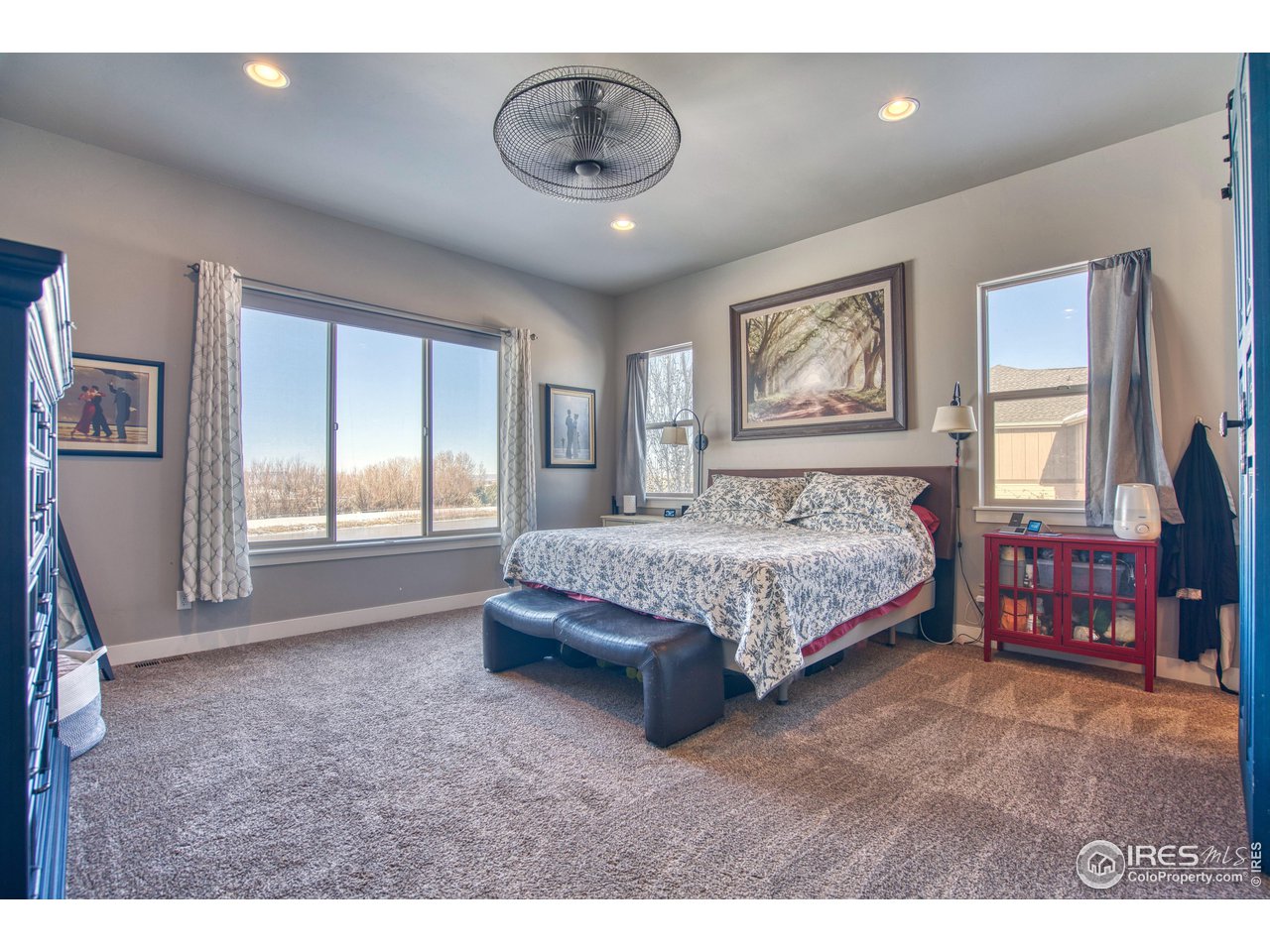 3941 Roper Trail Severance, CO 80524 - Photo 13 of 32 a spacious bedroom with a large bed and wooden floor