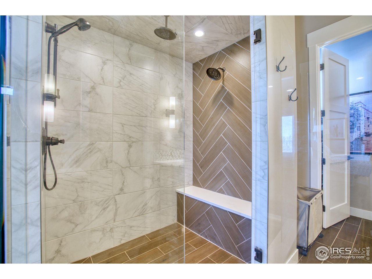 3941 Roper Trail Severance, CO 80524 - Photo 14 of 32 a bathroom with a glass shower door