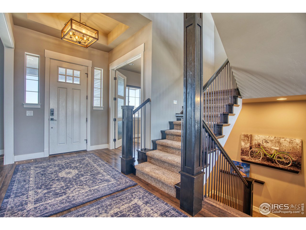 3941 Roper Trail Severance, CO 80524 - Photo 16 of 32 a view of a hallway with wooden floor and staircase